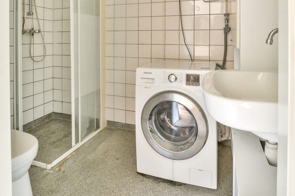 A washing machine inside a bathroom in the concept of keeping appliance safe during the move